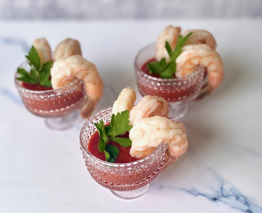 3 jumbo shrimp with sauce in glasses