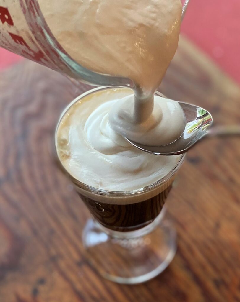 Gently pour cream over spoon