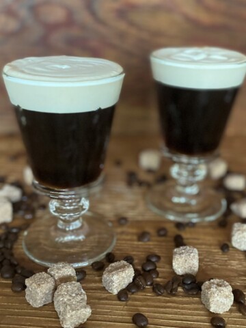 two Irish Coffees with sugar cubes