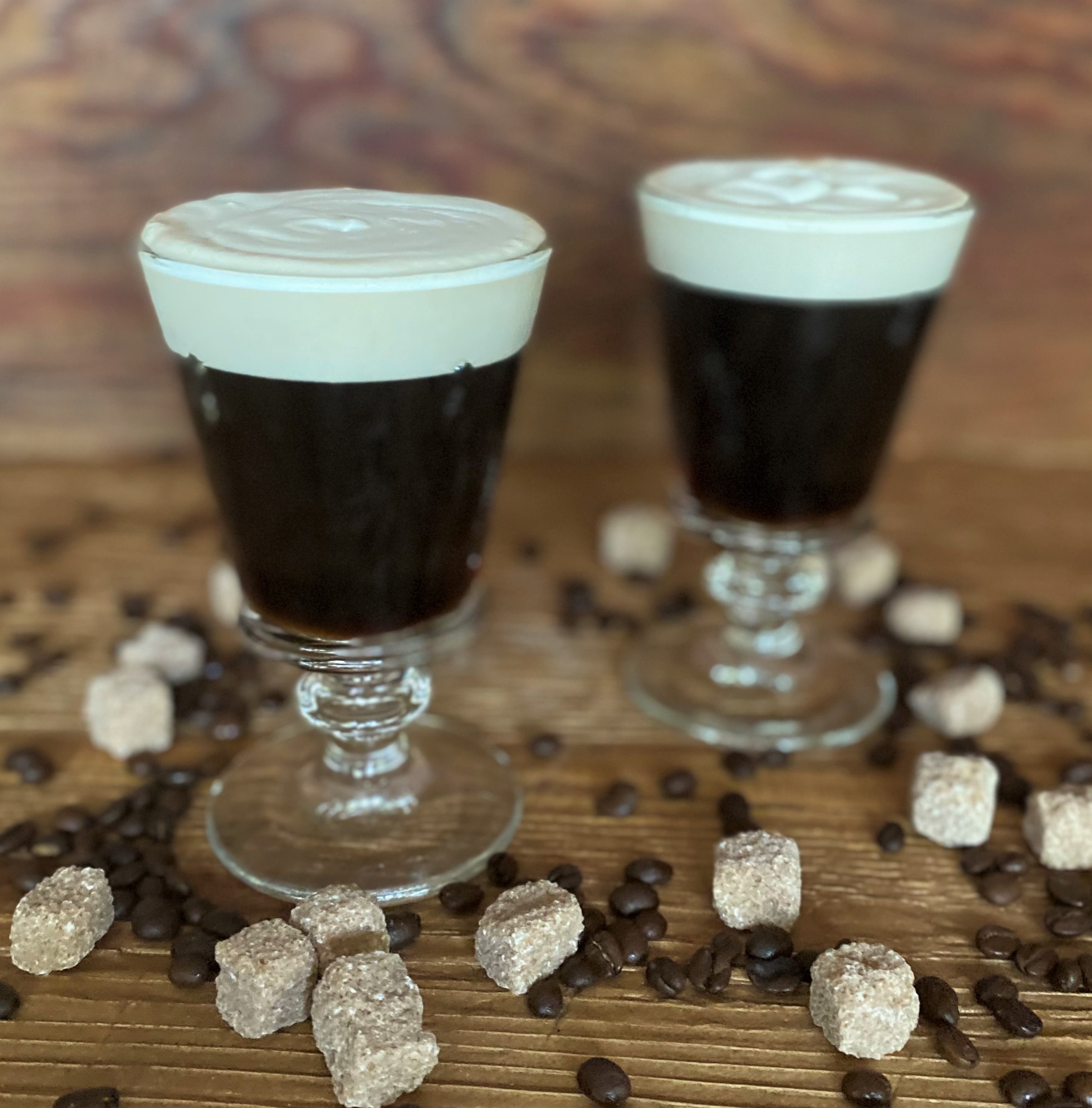 two Irish Coffees with sugar cubes