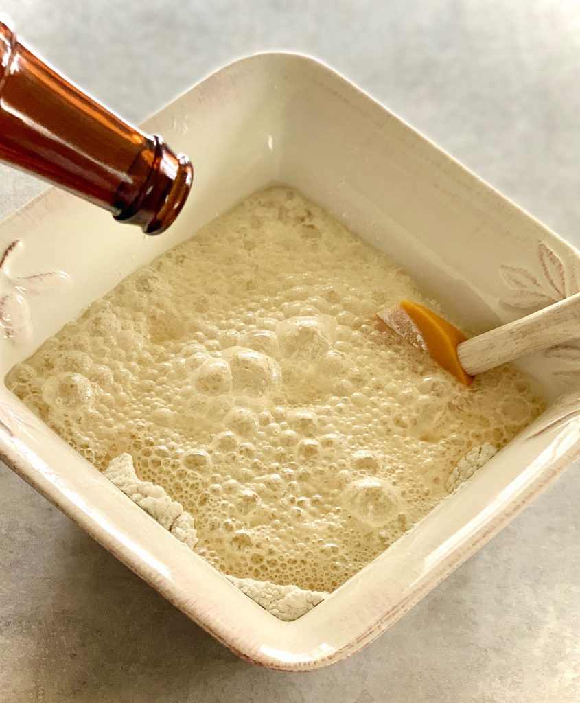 Beer being added to flour and sugar for bread