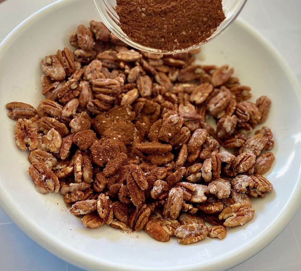 adding spices to nuts
