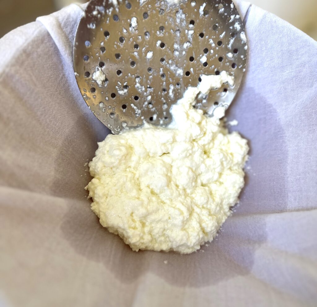 Scoop cheese into lined colander