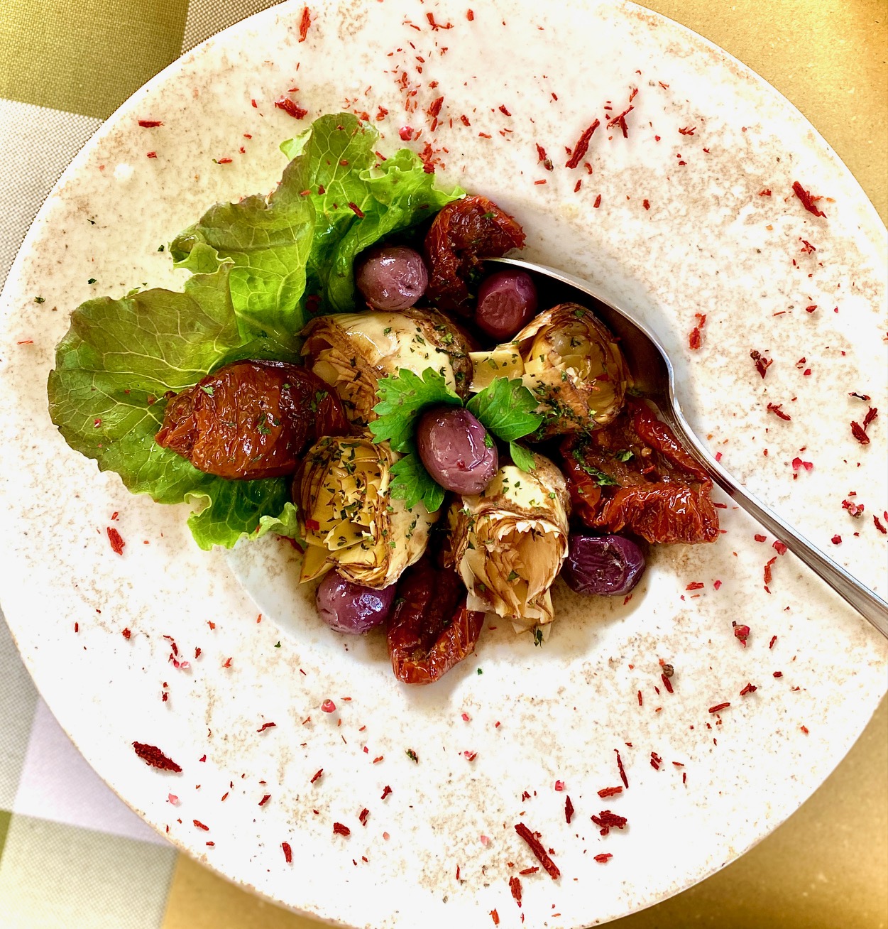 artichoke tomato olive salad in bowl