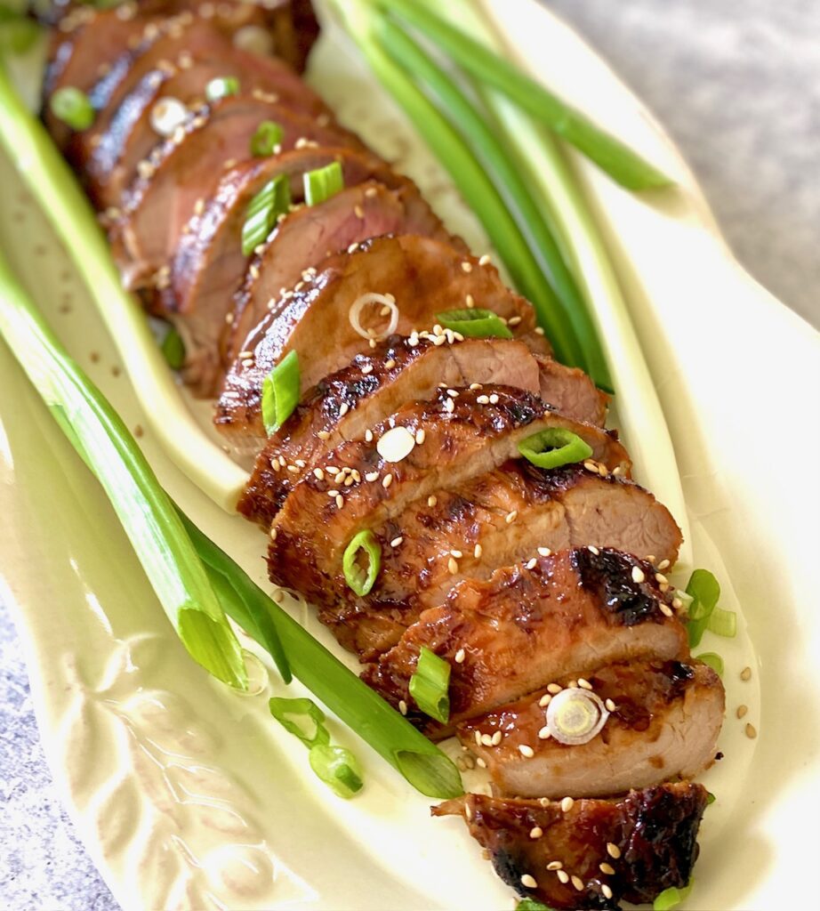 asian marinated tenderloin sliced on a platter