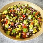 bamboo bowl containing mixed of corn and black beans