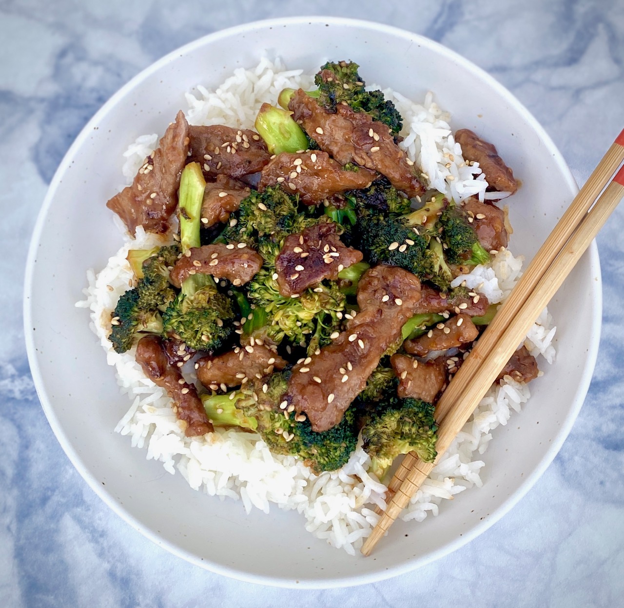 Beef Broccoli over rice in white bowl
