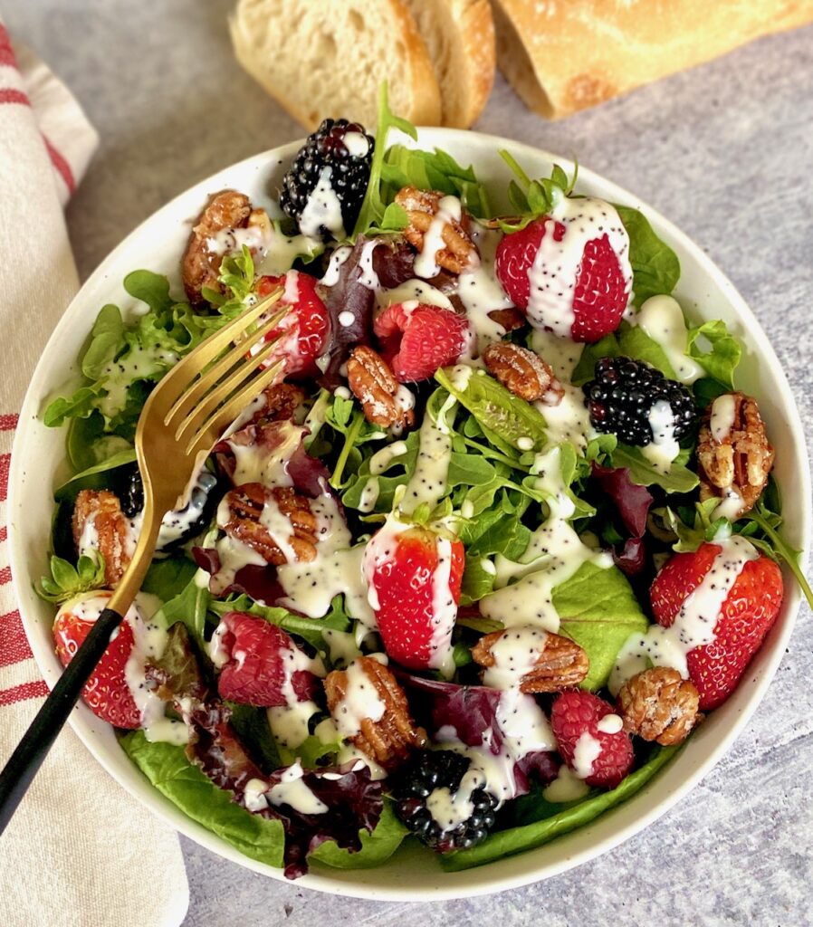 green salad with fork and berries