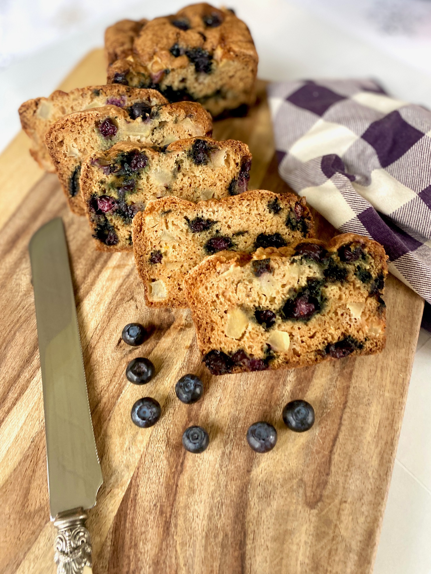 blueberry bread on board with knife