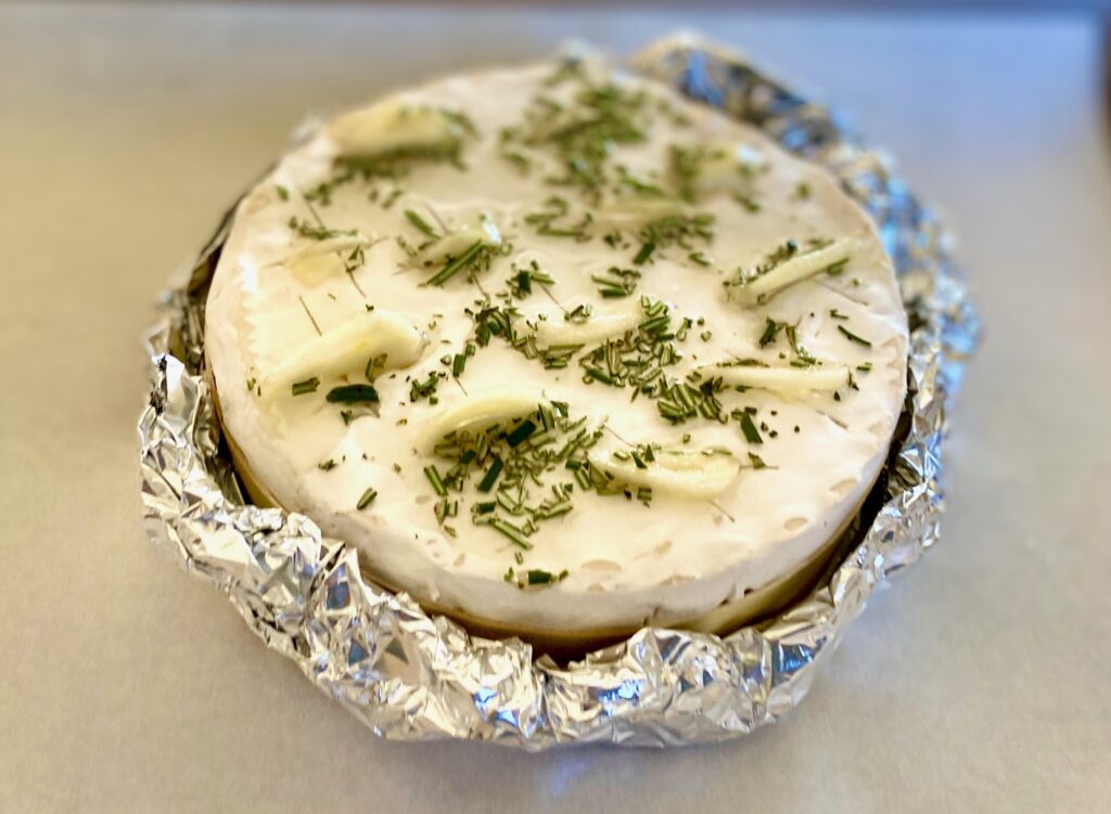 a wheel of cheese in foil
