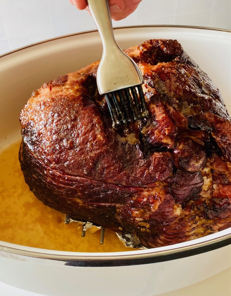 brushing glaze on a ham