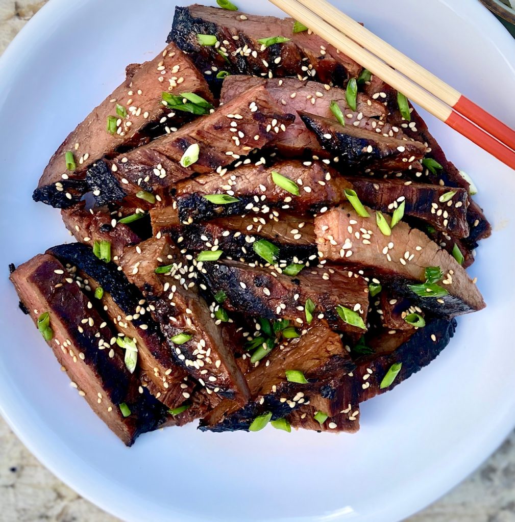 grilled bowl of steak with chopsticks