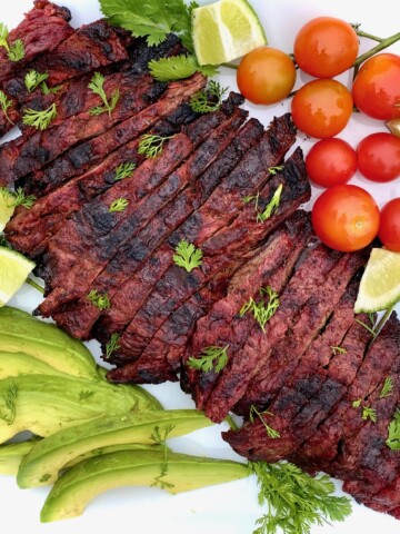 Carne Asada on a platter with vegetables