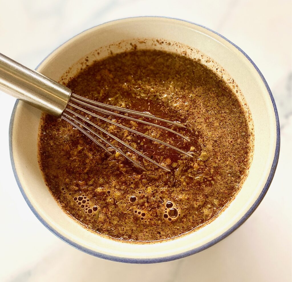 Carnitas sauce in a bowl with whisk