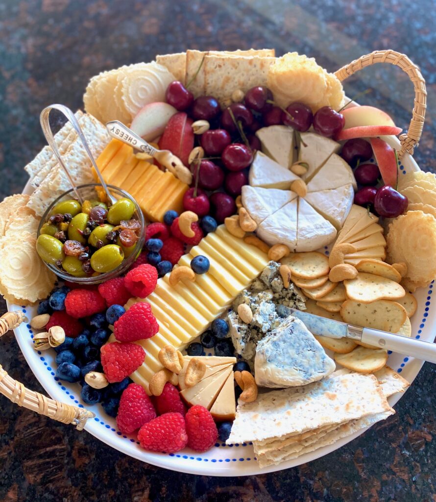 platter of cheeses, crackers and nuts