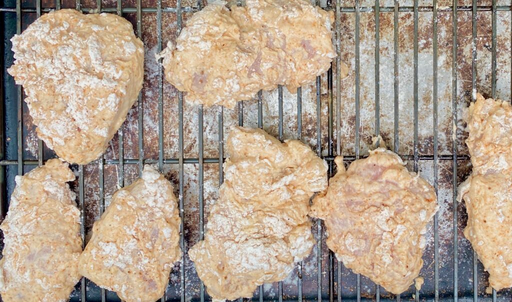 coated chicken on a rack