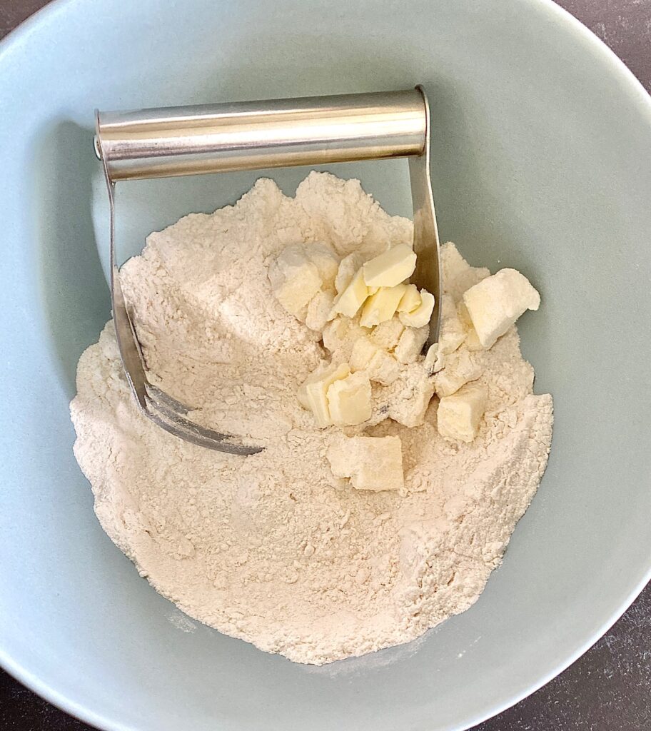 blue bowl with flower, butter pieces and pastry cutter