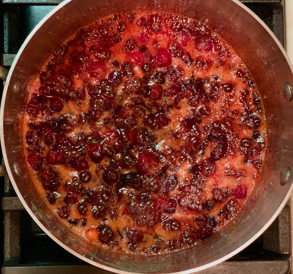 Cranberries cooking in a pan