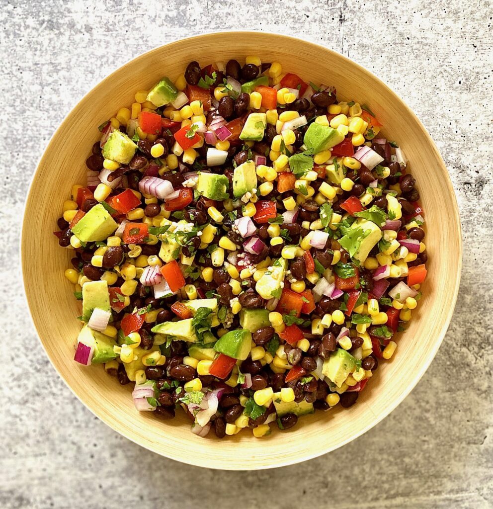 Corn mixed with black beans in bowl