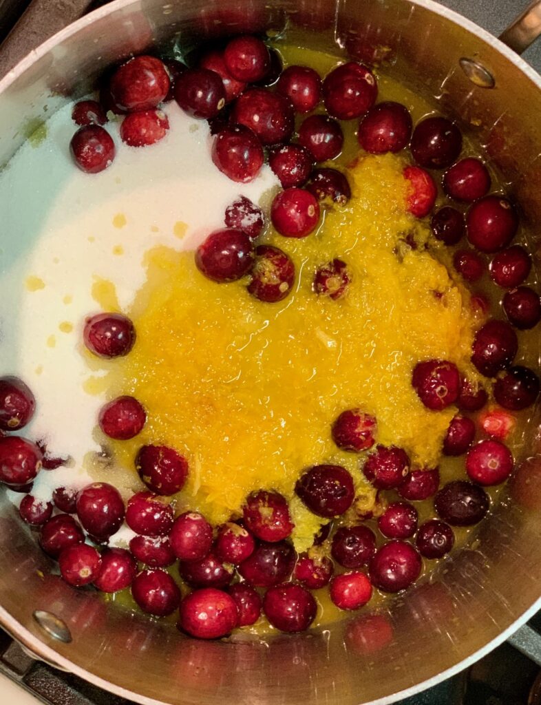 cranberries, orange and sugar in a pan