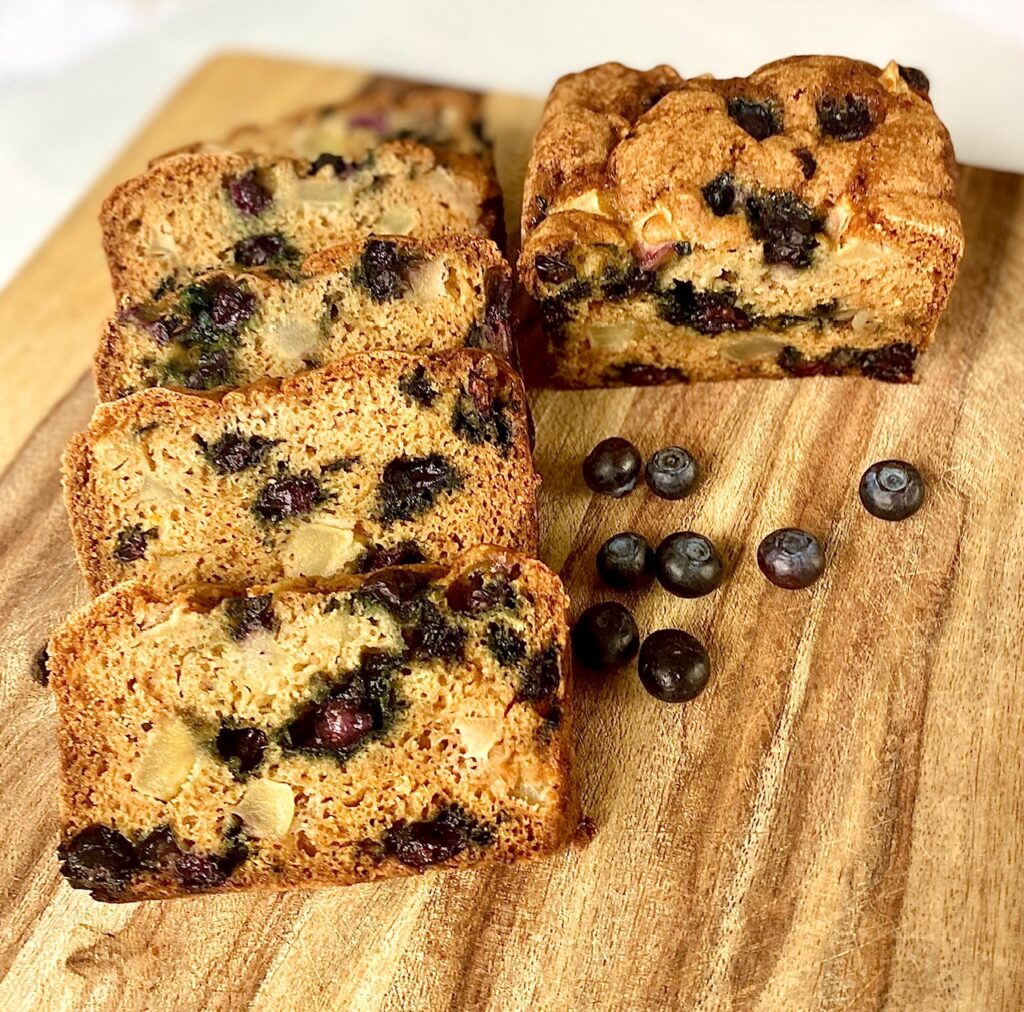 cut blueberry bread on a cutting board