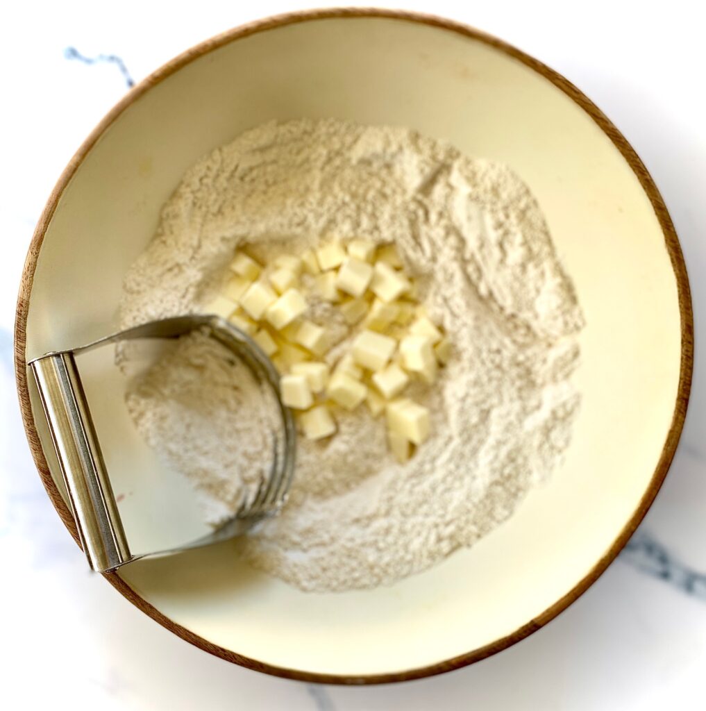 cutting butter into bowl