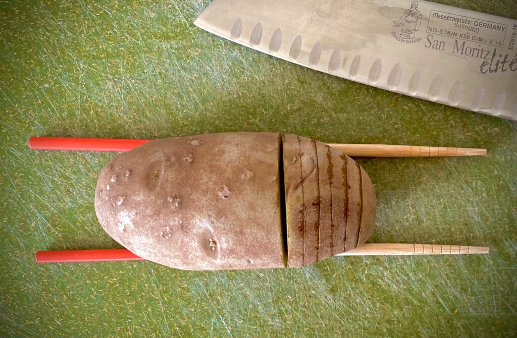 Cutting a potato into thin slices