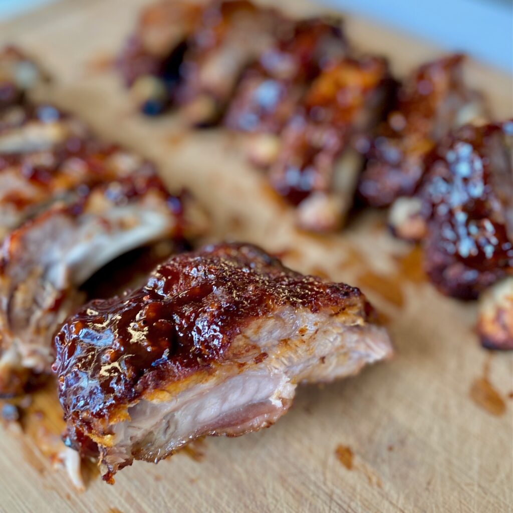 a platter of baby backs with sauce