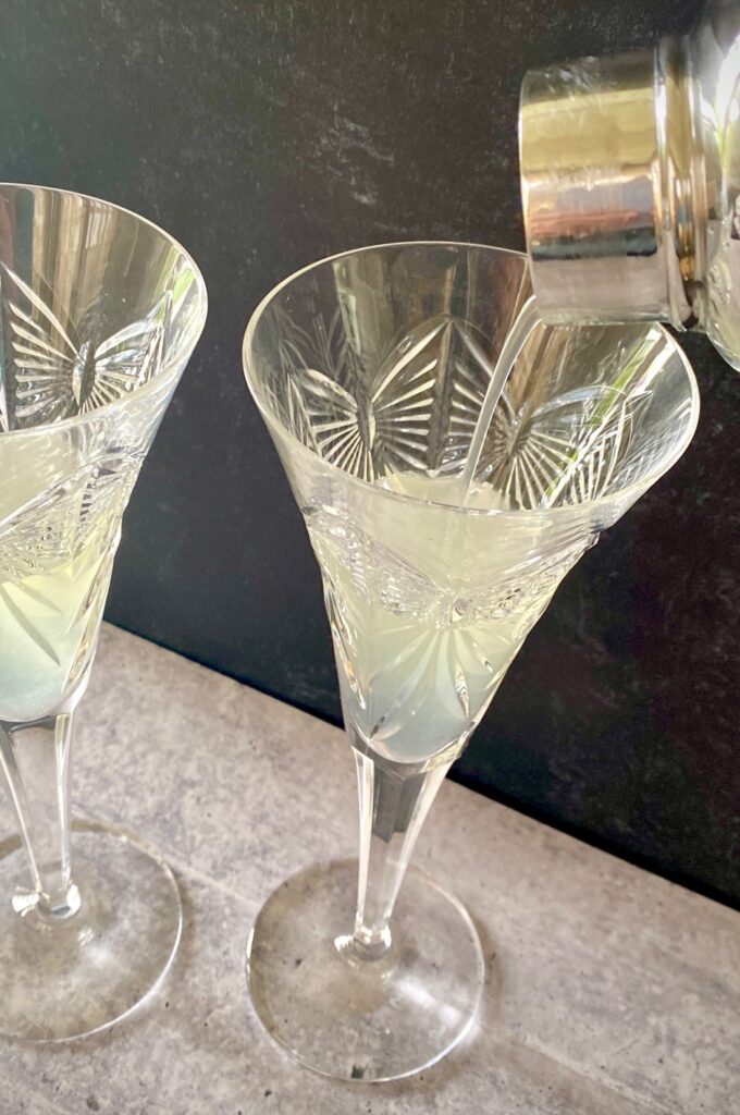 pour lemon cocktail into a champagne glass