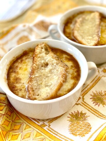 2 bowls of French Onion Soup with swiss cheese