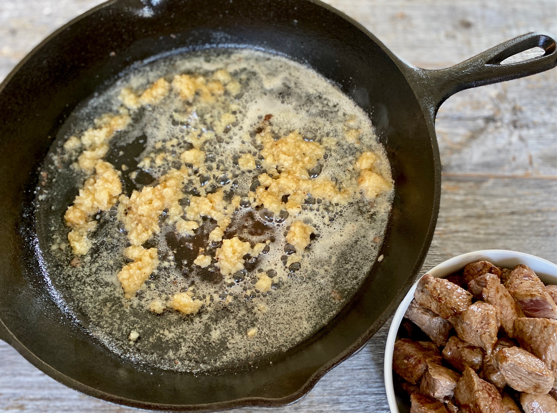 garlic and butter in cast iron pan