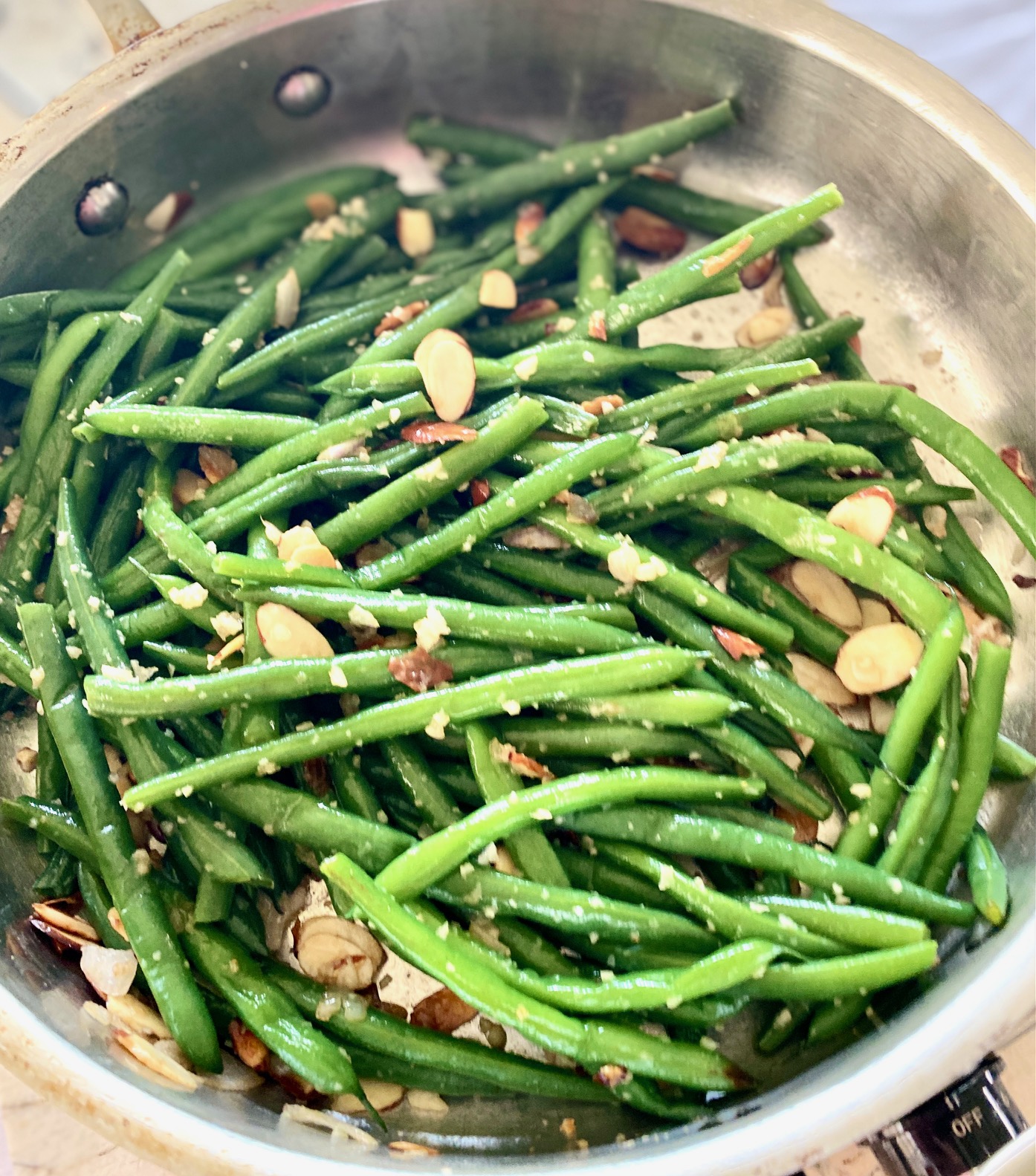 green beans, almonds, garlic and shallots in pan