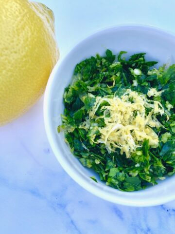 a lemon and a bowl of gremolata