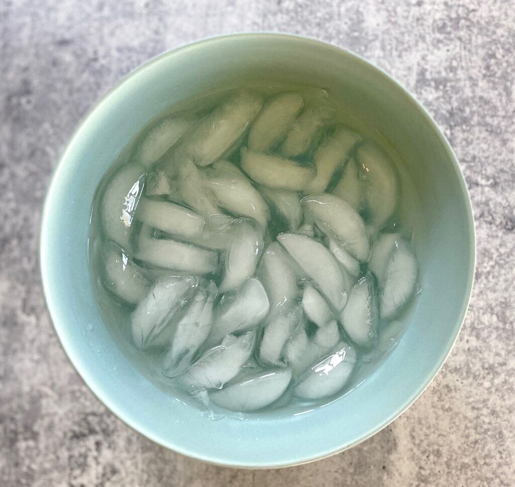 a blue bowl with ice water