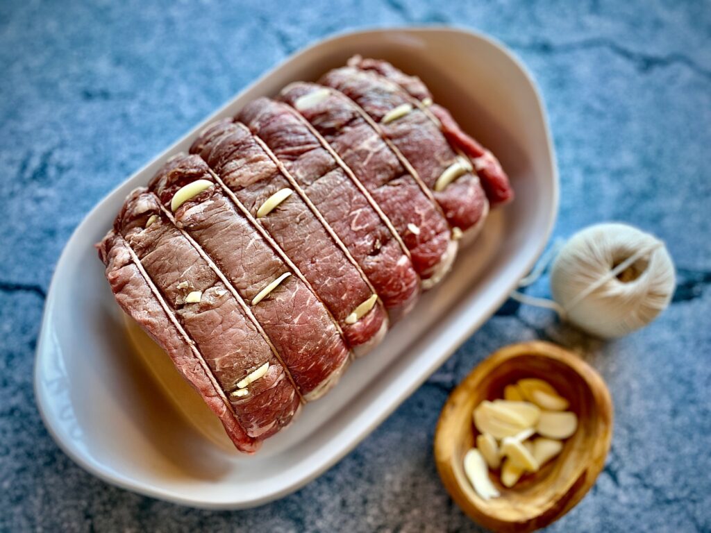 Insert slices of garlic into roast