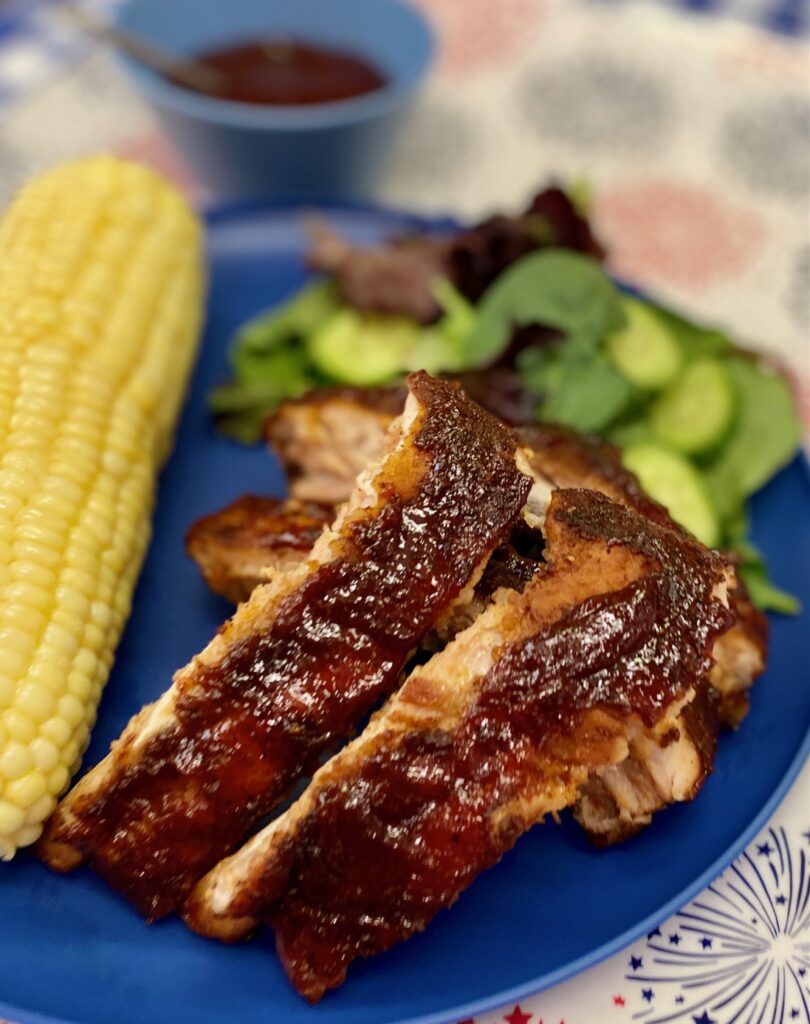 plate of smoked ribs plus corn and salad