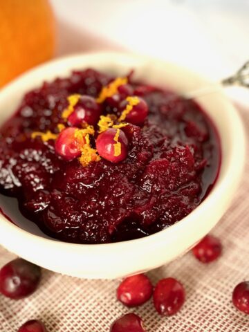 Cranberry Sauce in a white bowl with an orange