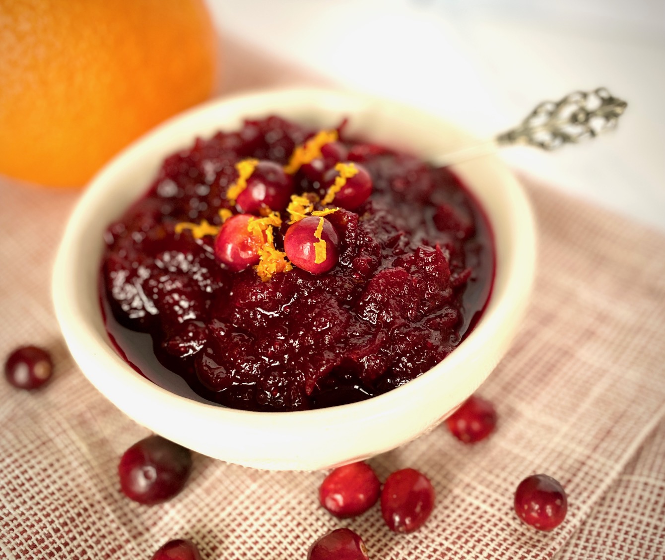 Cranberry Sauce in a white bowl with an orange