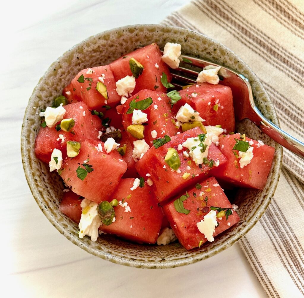bowl of individual watermelon salad with feta and a fork