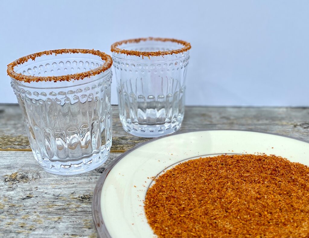 2 glasses coated in Tajin seasoning