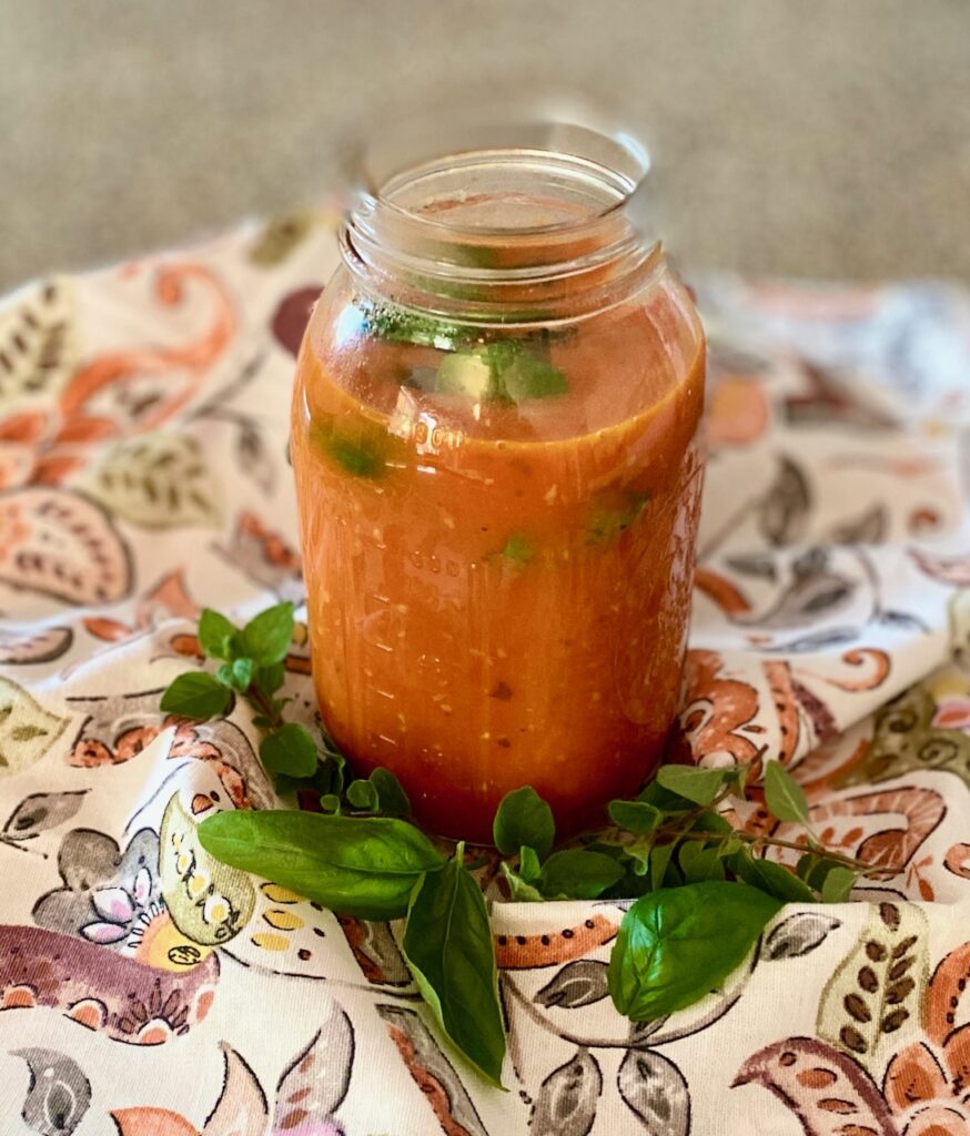 marinara in a canning jar with basil