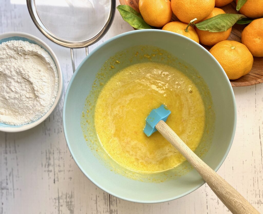 oranges, sugar, eggs, evo in a bowl