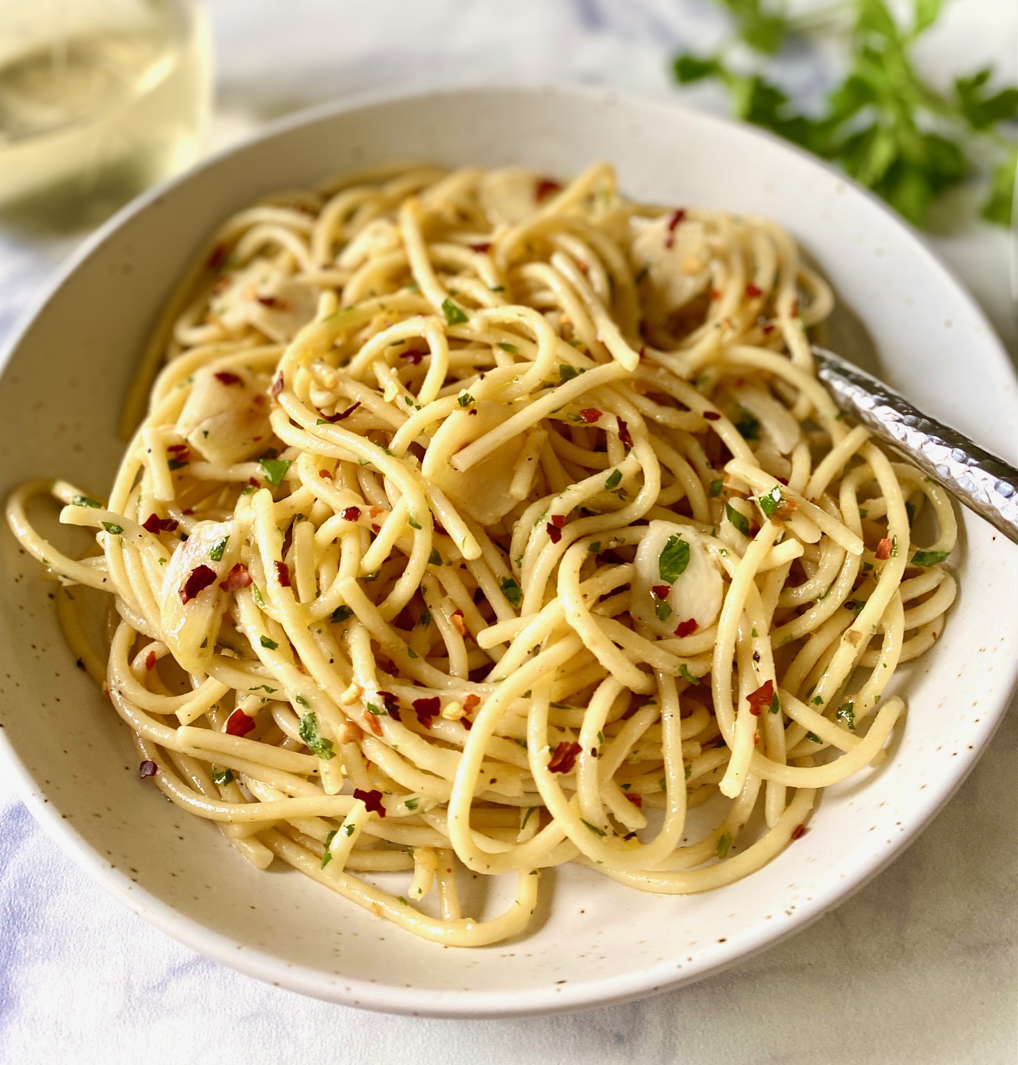pasta aglio e olio in a bowl with a fork