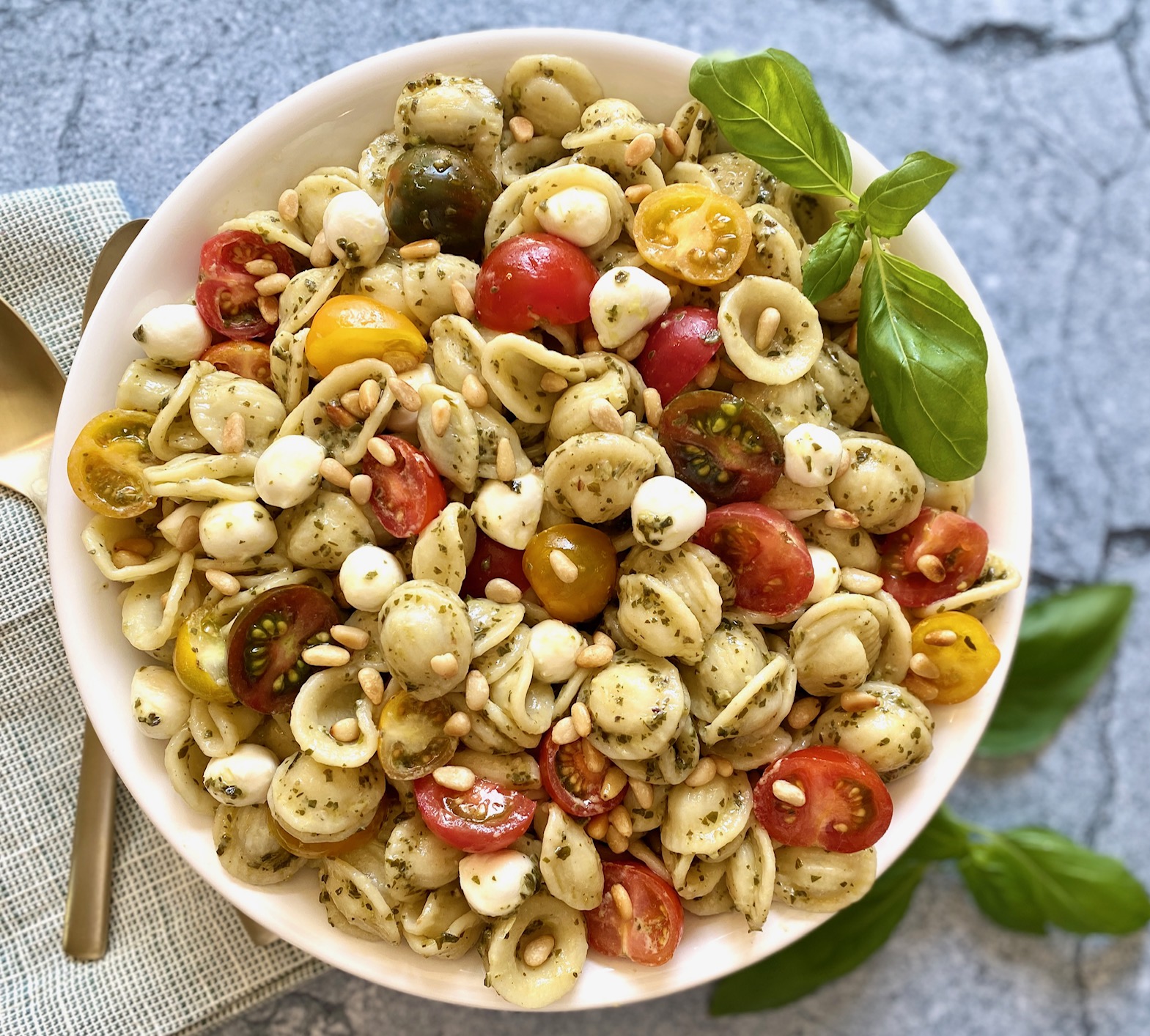 A bowl of pesto pasta salad