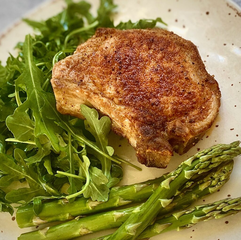 pork with vegetables on white plate