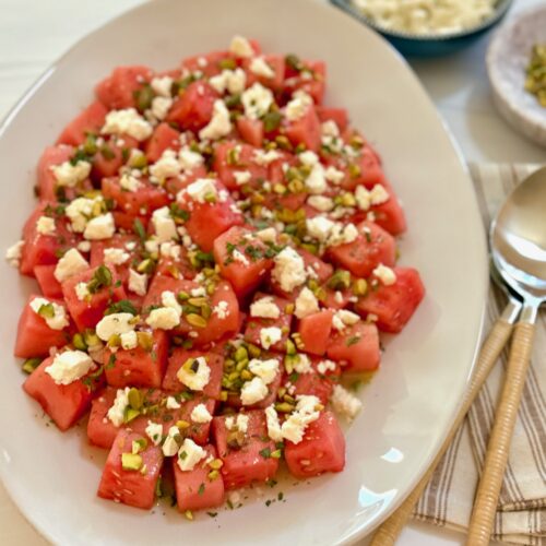 a platter of watermelon feta salad with spoon