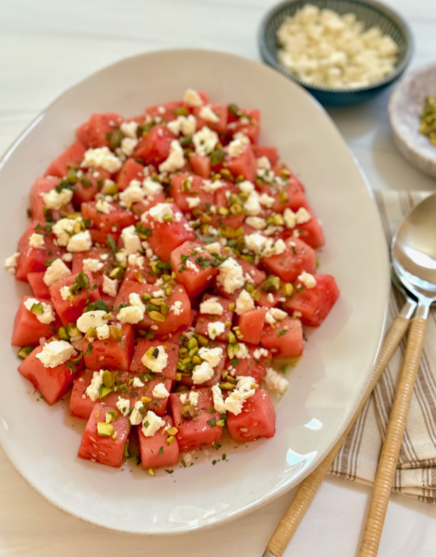 a platter of watermelon feta salad with spoon