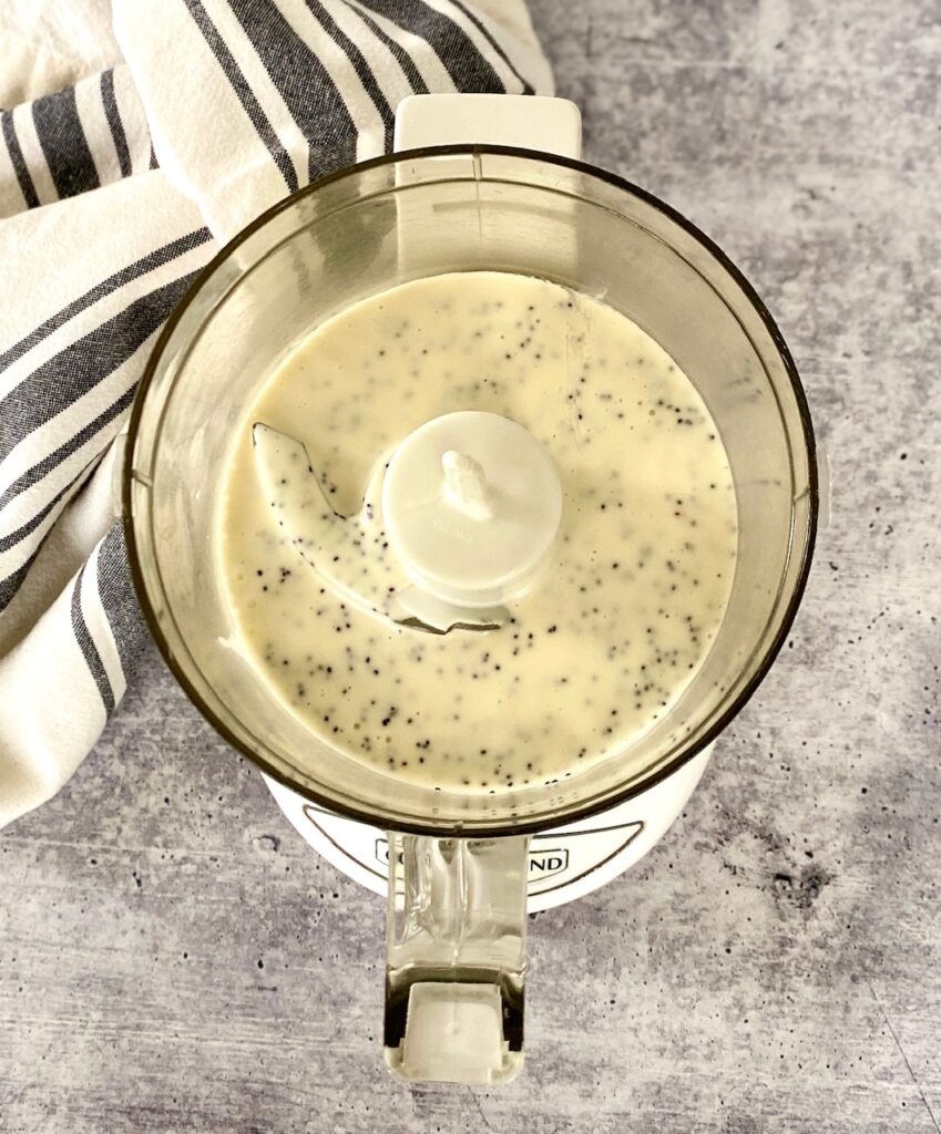 Ingredients for salad dressing in a small food processor