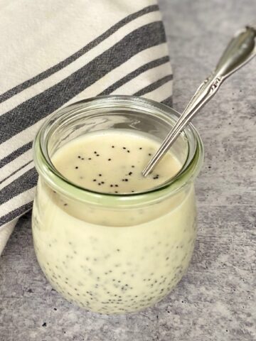 Poppy seed dressing in jar with a spoon