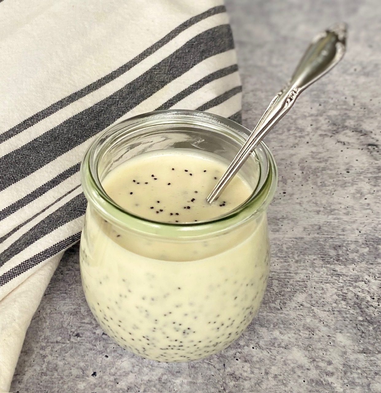 Poppy seed dressing in jar with a spoon